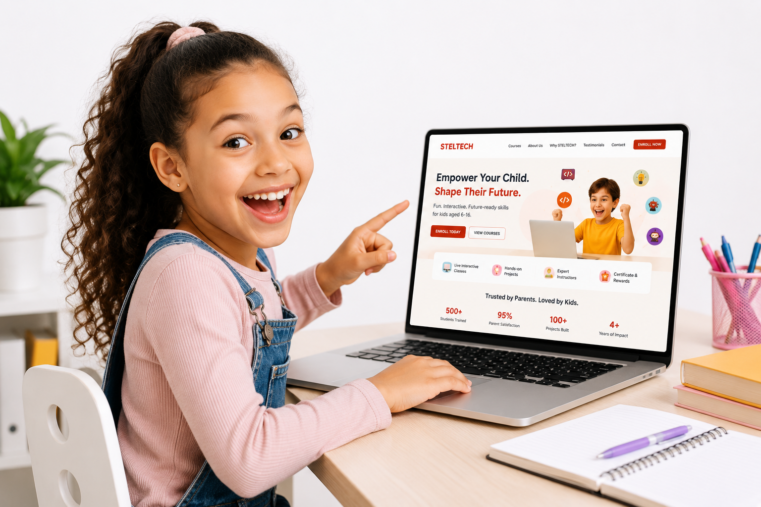 Happy child learning on a laptop at STELTECH